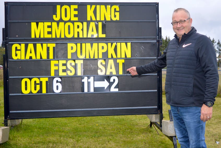 Ron Ivey, president of the Millville Community Centre, points at the sign for the annual Joe King Memorial Giant Pumpkin Festival, which takes place Saturday at the community centre in Millville.