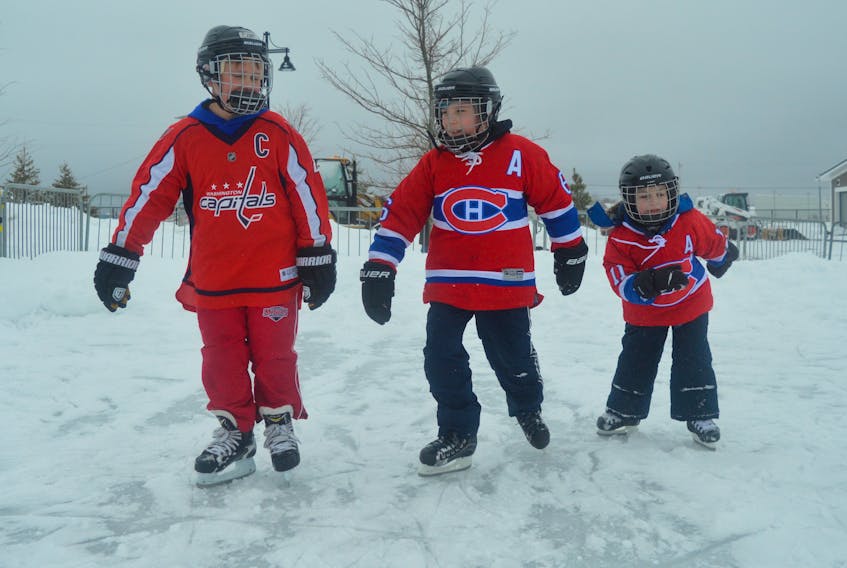 From left, Cale Buchanan, Caiden Romeo and Logan Romeo wore their favourite hockey jerseys for a skate around the outdoor rink at Open Hearth Park in Sydney last year. The rink will not be back this winter.
