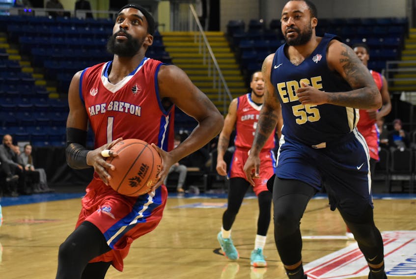 Bruce Massey of the Cape Breton Highlanders, left, looks towards the basket as Junior Cadougan of the St. John’s Edge follows during National Basketball League of Canada action at Centre 200 on Tuesday. Massey and the Highlanders will be back on home court tonight at 7 p.m. to play the Island Storm.