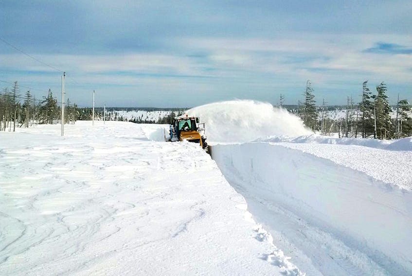 A specialized snow blower attempts to clear some of the massive snowbanks found last month on top of North Mountain.