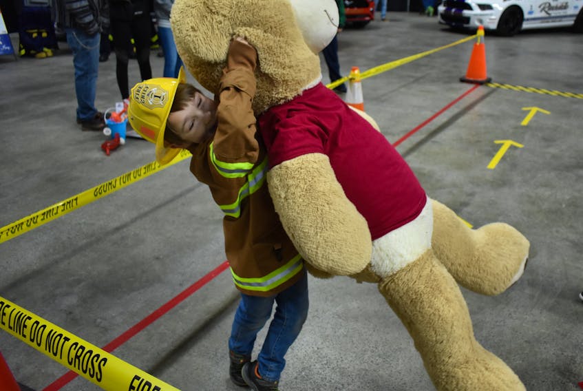 Six-year-old Timmy Timmons pulls a giant teddy bear to safety to complete a series of firefighting tasks on an obstacle course for kids that was set up by CBRM Fire Services at the Sydney venue of the 27th annual IWK Telethon on Sunday. Centre 200 was filled with displays, children’s activities, entertainment and donation desks where volunteers either worked the phones or dealt with donors in person. The event was broadcast out of CTV Atlantic’s Halifax studios featuring segments out of Sydney, Saint John, N.B. and Charlottetown, P.E.I.