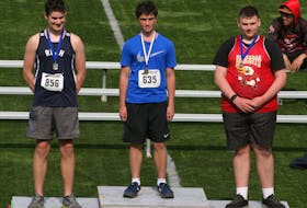 From left, Rylan Murphy of Rocky Lake, Owen Minihan representing Malcolm Munroe Middle School and Seth Channing of Sackville Heights stand on the podium following the junior boys discuss competition at the Nova Scotia School Athletic Federation track and field championships in Wolfville on Saturday. Minihan took the gold medal in the event.