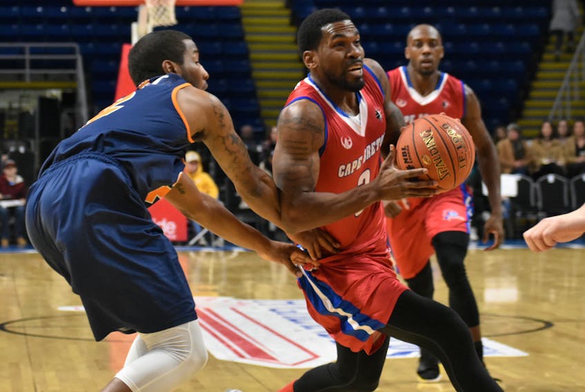 Justin Taylor of the Cape Breton Highlanders, right, drives the lane as Tyler Scott of the Island Storm defends during National Basketball League of Canada action at Centre 200 on Thursday.