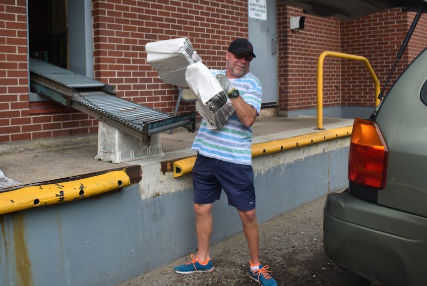 Darrell Jardine loads up a vehicle with advertising flyers at the Cape Breton Post distribution centre. Jardine is part of a team of more than 50 people responsible for distributing more than 38,000 bundles of flyers across the region.