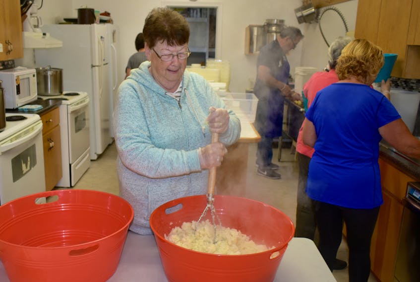 Cynthia Berezuk puts her energies into mashing up a giant bowl of potatoes on Wednesday at the Bra d’Or Seniors and Pensioners Club in preparation for Friday’s annual fall fair. The day-long event runs at the Main Street building from 10 a.m. to 5 p.m. and features a ham and potato salad dinner topped off with homemade pie. A flea market and craft and bake sales are also on the agenda.