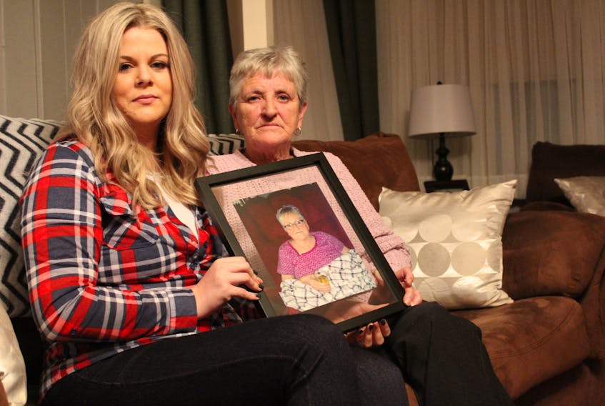 Lisa Wylde, left, and Cecelia Farr hold a picture of Edna Whitty, who died on Nov. 3 as a result of self-inflicted burns she received while under the care of the Northside Community Guest home. Farr, her sister, and Wylde, her granddaughter, are looking for answers regarding why Whitty was left unsupervised with a lighter and have other concerns about her care over the nine months Whitty was at the long-term-care facility.