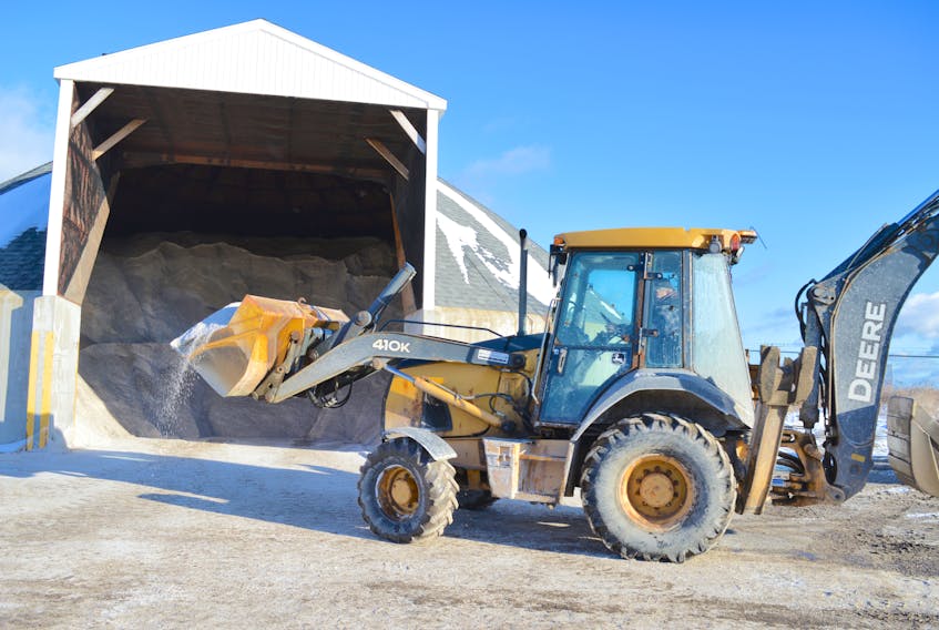 Billy Thomson, a worker with Cape Breton Regional Municipality public works in east division, scoops up salt from the new salt shed in Glace Bay.