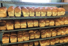 Freshly-baked bread cools on racks at the family-owned Aucoin Boulangerie in Cheticamp.