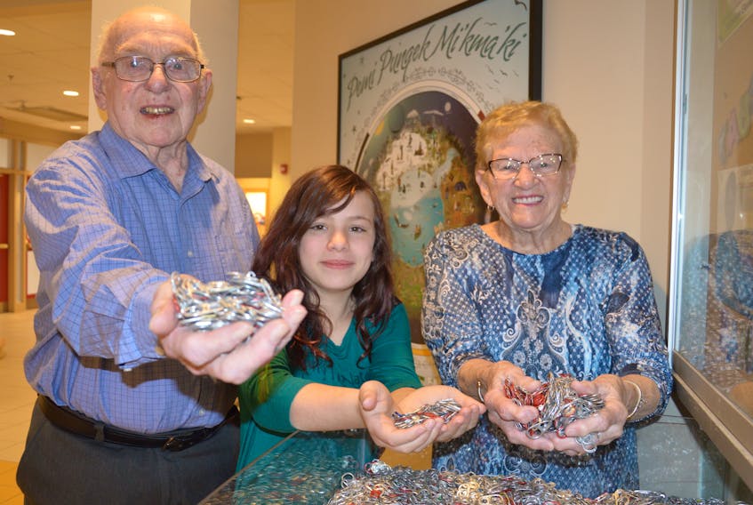 From left, Alfred Landry, Abby Ronayne and Jean Landry picked up aluminum can tabs at Ferrisview Elementary School in North Sydney this week. Over the course of the year, students and staff collected the tabs for the Landrys on behalf of their grandson, Daniel Arsenault of Trenton. The tabs are used to raise money for children in need of wheelchairs across the province.