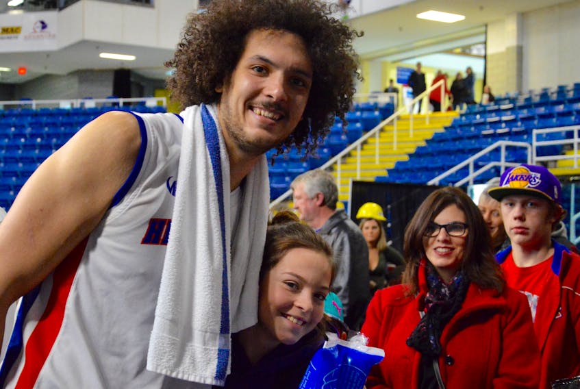 Aly Ahmed of the Cape Breton Highlanders poses with a fan following a National Basketball League of Canada game at Centre 200. The 25-year-old centre from Alexandria, Egypt, is in his first season of professional basketball.