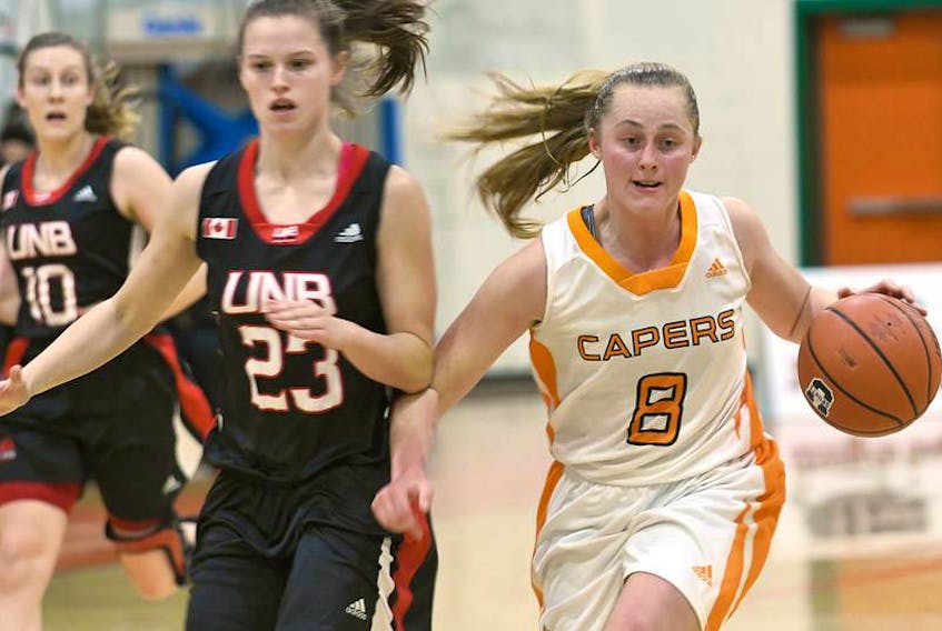 Madison Munro of the Cape Breton Capers women's basketball team, right, carries the ball during Atlantic University Sport action earlier this season. Munro’s AUS career come to an end on Saturday when the Capers lost to Memorial Sea-Hawks in the championship semifinals in Halifax.