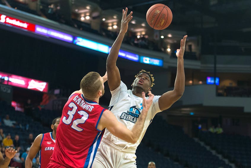Halifax Hurricanes forward Meshack Lufile tries to corral a rebound in front of Cape Breton Highlanders centre Tanner Giddings during the first half of Thursday night’s NBL Canada playoff game at the Scotiabank Centre in Halifax.
