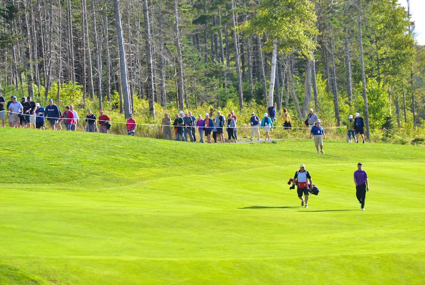 Mark Silvers of Savannah, Ga., right, and his caddy walk down the 18th fairway of The Lakes Golf Club in Ben Eoin during the Cape Breton Celtic Classic in this Sept. 7, 2014 file photo.