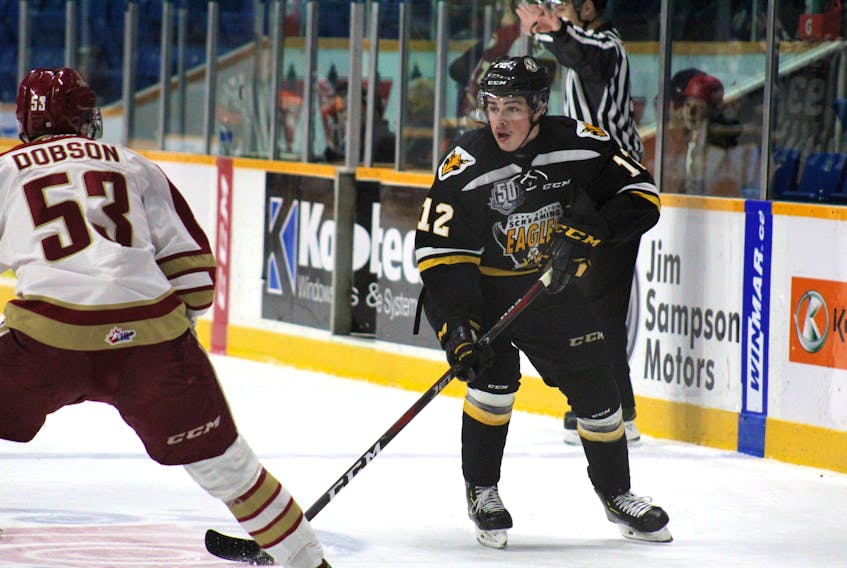 Wilson Forest of the Cape Breton Screaming Eagles, right, carries into the Acadie-Bathurst zone while being watched by Noah Dobson of the Titan during Quebec Major Junior Hockey League play Sunday at Centre 200. Cape Breton cruised to a 6-2 win