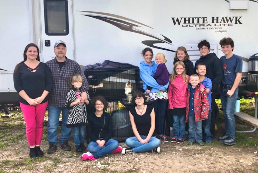 The Durant family of New Waterford gather in front of their camper, which they’ve named “Trailer Swift,” while in the midst of their year-long tour around Canada and the United States. From left, Lindsay, 42, Cory, 48, Na’arah, 7, Tirzah, 14, Tabitha, 19, Azaria, 21, Odelia, 2, Vashti, 11, Shemayah, 5, Adoniyah, 9, and in back from left, Gabrielle, 13, Isaias, 18, and Tobias, 16. The family of 13 children includes Zailynne Durant, 22, now married and living in Sydney and Kayleb, 24, now of Prince Edward Island.
