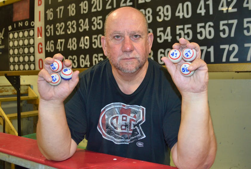Kevin Forward, manager of the New Waterford and District Community Centre, holds some bingo balls in front of the bingo board at the centre. Forward said after 40 years of the centre providing bingo to the community and it being a major fundraiser for the rink, due to a severe decline in attendance a decision was made to close the bingo down.