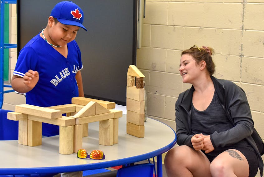 Renee Connors and Dare Crane build block towers during a Teach for Canada training program in Big Grassy River First Nation, an Ojibway community in Northwestern Ontario, in this July photo. Connors, a 25-year-old Port Hawkesbury native, is heading to Fort Severn First Nation, the northern-most community in Ontario, to teach Grade 7 and Grade 8.
