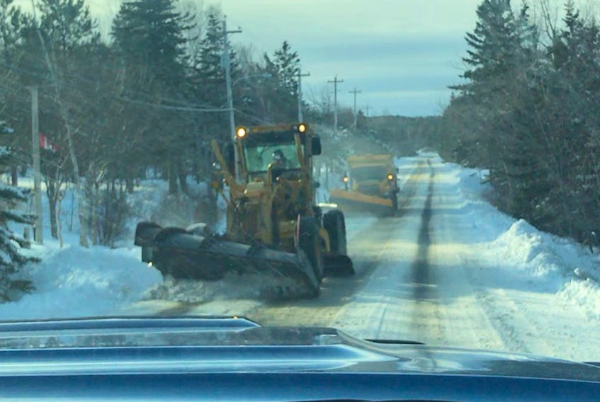 A snowplow and salt truck tackle the snow-filled roads in Main-a-Dieu on Friday. CBRM District 8 Coun. Amanda McDougall said the roads hadn’t been plowed since a New Year’s Day storm.