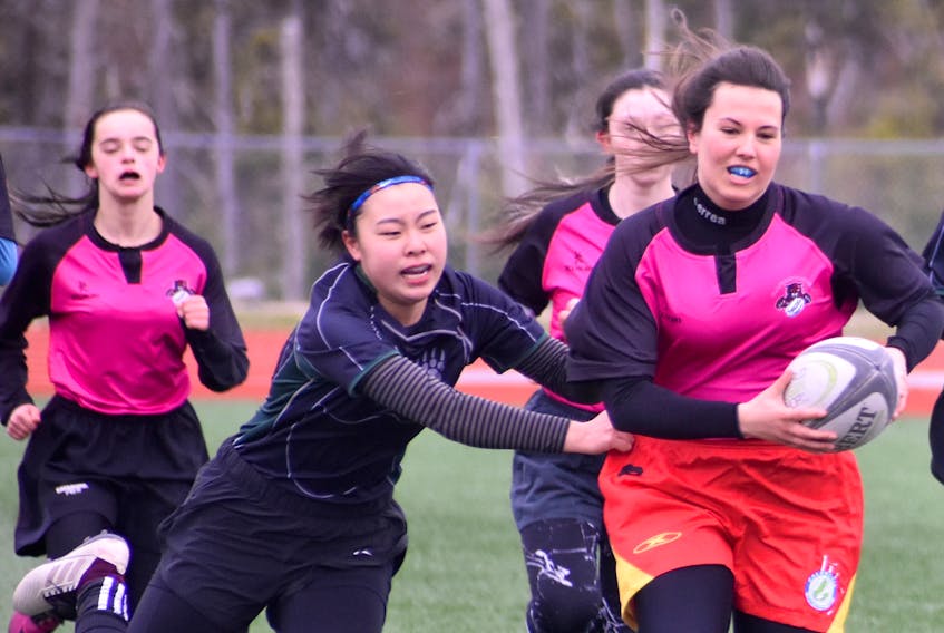 Elena Calaterra of the Glace Bay Panthers carries the ball while Miyabi Matsute of the Breton Education Centre Bears tries to take her down during Cape Breton High School Rugby League action at Cape Breton University on Monday of last week, just days before the cancellation of their season. The Nova Scotia School Athletic Federation cancelled the 2019 rugby season last Thursday because of insurance issues.