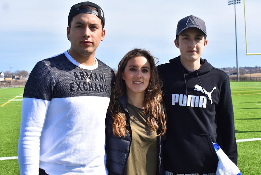 Mexican exchange student Diego Kuri, right, is shown with brother Gabriel and mother Erika during a rally of support for the 16-year-old who was injured in a Sydney Academy high school rugby game last week. Kuri, who escaped serious injury, says he’s feeling fine and is calling on the NSSAF to reinstate rugby after it cancelled the sport last week in a decision unrelated to his on-field incident.