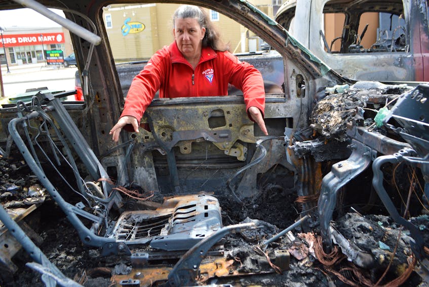 Jeanette MacDonald, secretary of the Glace Bay Y’s Men’s and Women’s Club, looks inside the club’s 2008 Envoy, in the parking lot of the Town Bowling Lanes — which is also owned by the club. It was one of two of the club’s vehicles destroyed by fire on May 2. The Cape Breton Regional Police Service says the fire has been deemed suspicious and they're investigating.