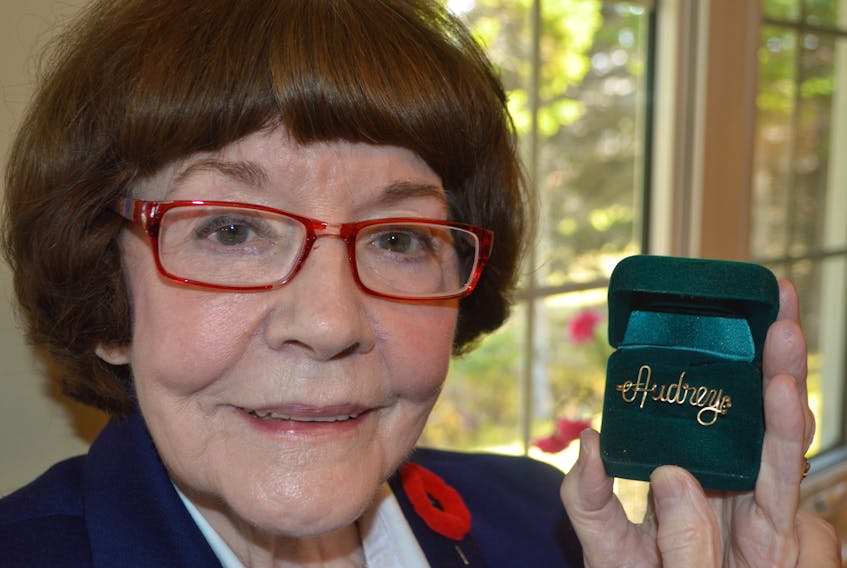 Audrey Greenhalgh shows a pin of her name given to her as a little girl by a soldier named Johnny 75-years ago who asked her to remember him. Greenhalgh said she has never forgotten the soldier and always wears the pin on Remembrance Day.