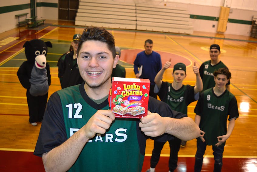 Dylan Messervey of the Breton Education Centre Bears holds up a box of Lucky Charms while team members and mascot Breton Eddie look on at the high school in New Waterford this week. The team started a tradition at Coal Bowl Classic 2016 of eating Lucky Charms before games and emerged as champions. The 36th annual Coal Bowl Classic high school basketball tournament began Monday with the Bears maintaining the Lucky Charms tradition and they won their first game.