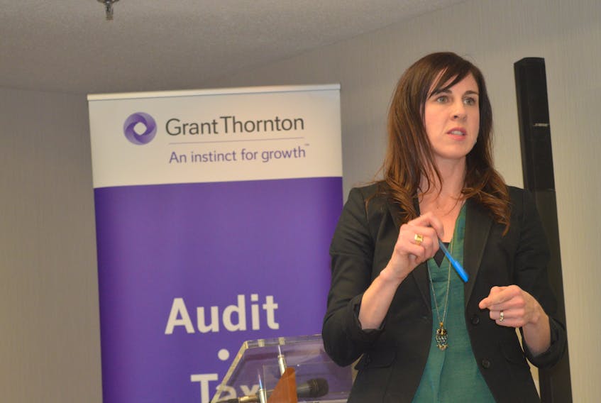 Carroll Vickers, senior manager at Grant Thornton LLP, speaks to a business crowd at a luncheon Tuesday at the Cambridge Suites in Sydney, explaining new taxation policies.