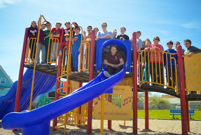 Grade 5 students in Tracey Munro’s class at Jubilee Elementary School stand on the Miners Memorial Playground equipment earlier this week. The grand opening of the playground will take place on Friday at the Sydney Mines school.