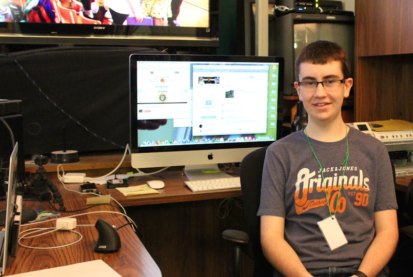 Adam MacLean, 16, sits near one of the computers used to manage social media accounts like Twitter during the annual Coal Bowl Classic on Jan. 4. The high school basketball tournament gives Breton Education Centre students like MacLean a chance to learn hands-on audio video production skills through managing social media and the Coal Bowl live stream produced by Crew Productions in New Waterford.