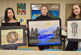 Shown with their artworks are Whitney Pier Middle School Grade 8 students Michelle McIsaac, from left, Katie Clemens and Kayla Baldwin. The students and art teacher Krista Starzomski are getting ready for a student art show that will take place at the Mayflower Mall from Tuesday until April 30.