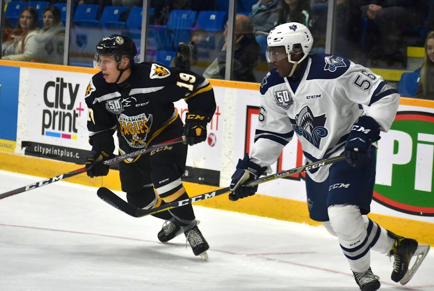 Shaun Miller of the Cape Breton Screaming Eagles, left, and Christopher Inniss of the Rimouski Océanic skate into the circle following a faceoff in the Océanic end during a Quebec Major Junior Hockey League game between the two teams at Centre 200 in this file photo. Cape Breton and Rimouski are tied 1-1 in their best-of-seven QMJHL second-round playoff series, with Game 3 on Tuesday in Sydney.