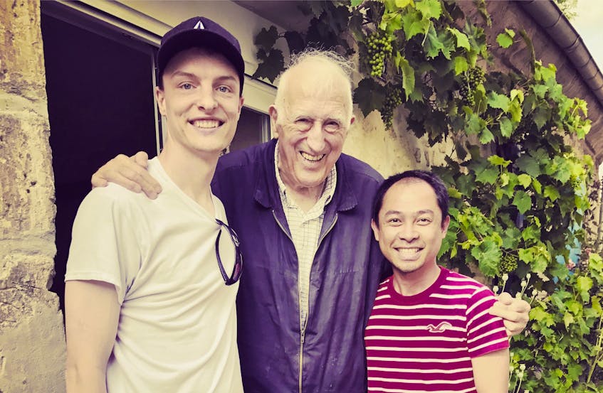 Jean Vanier, centre, poses for a photograph at L’Arche Trosly in France with Cape Breton development team member Matt Pain, left, and local L’Arche executive director Mukthar Limpao.