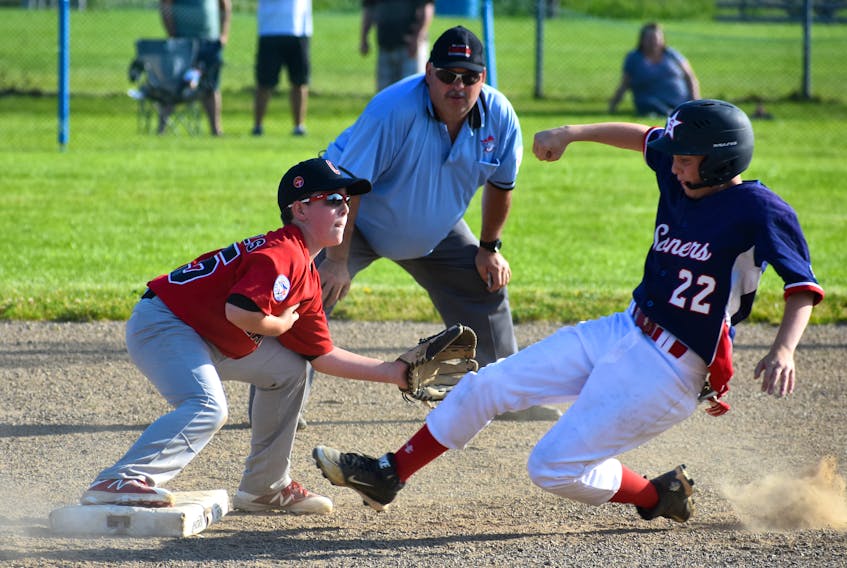 Anthony Lecky of the Sydney Sooners slides safely into second base before the ball reaches Garrett MacIntosh of the Glace Bay McDonald’s Colonels during play at the 2018 Nova Scotia Major Little League Championship at Vince Muise Field in Sydney River on Sunday.