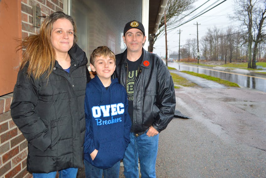 Stephanie MacPhee of Bridgeport stands with her son Connor, 11, and partner Gary McNeil, near the former Breezeway Convenience Store, her son’s school bus stop. MacPhee said on Nov. 1 her son accidently missed his stop and three following it, and the driver simply left him stranded at the final bus stop, two kilometres from home.