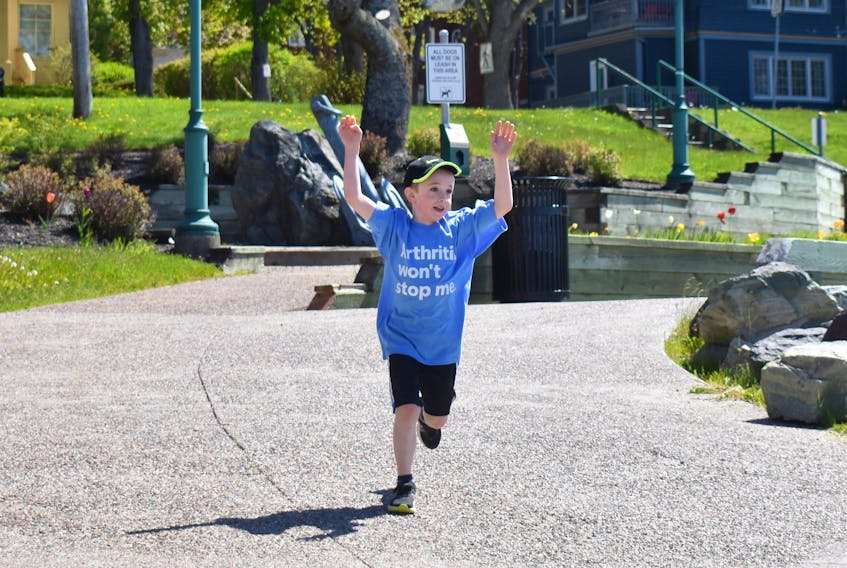 Six-year-old Josh MacDonald raises his arms as he nears the finish line of Sunday’s Walk for Arthritis on the Sydney waterfront. The Cusack Elementary School student was diagnosed with juvenile arthritis at age two and the condition affects more than five joints. The youngster was having a good day and his enthusiasm was contagious and inspiring to the two-dozen participants who began and finished at the Joan Harriss Cruise Pavilion.
