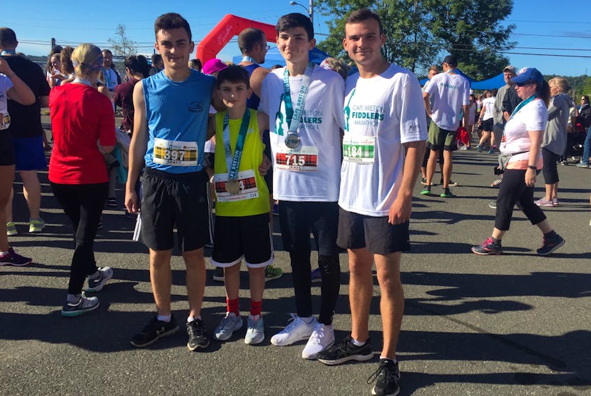 From left, Brady Steiger, 17, his brother Colby Steiger, 13, and their cousins, James Martin, 14, and Brandon Martin, 17, take time for a picture after finishing the Cape Breton Fiddlers Run on Sunday. The four are all members of the Royal Canadian Sea Cadets Corps No. 70 in New Waterford and said being cadets is what got them into running.