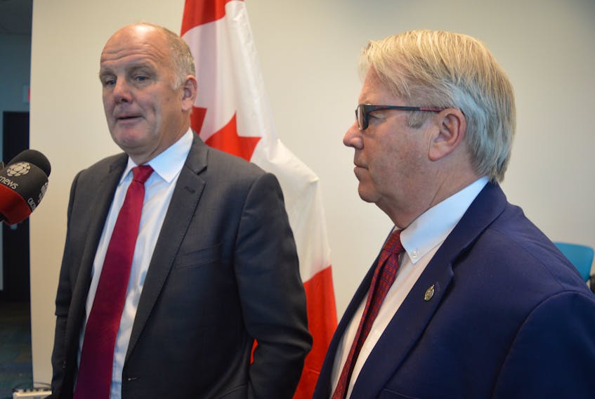 Sydney-Victoria MP Mark Eyking, left, and Cape Breton-Canso MP Rodger Cuzner speak to reporters after announcing that 44 new federal payroll support jobs under Health Canada will come to New Waterford next month.