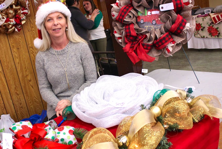 Glace Bay’s Krista MacLean of Deco Designs was busy selling her homemade wreaths using materials such as burlap, mesh and garland at a Christmas fair at the Reserve Mines fire hall Saturday.