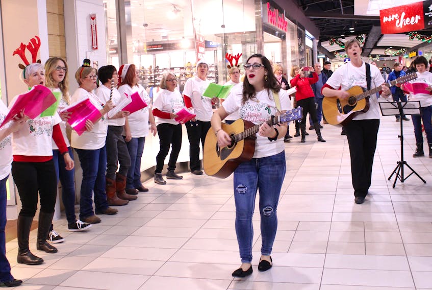 Guitar players and music therapists Alyssa Rockwell, left, and Jill Murphy led a group of Cape Breton palliative-care workers, doctors, volunteers and their supporters in a musical flash mob at the Mayflower Mall on Saturday afternoon.