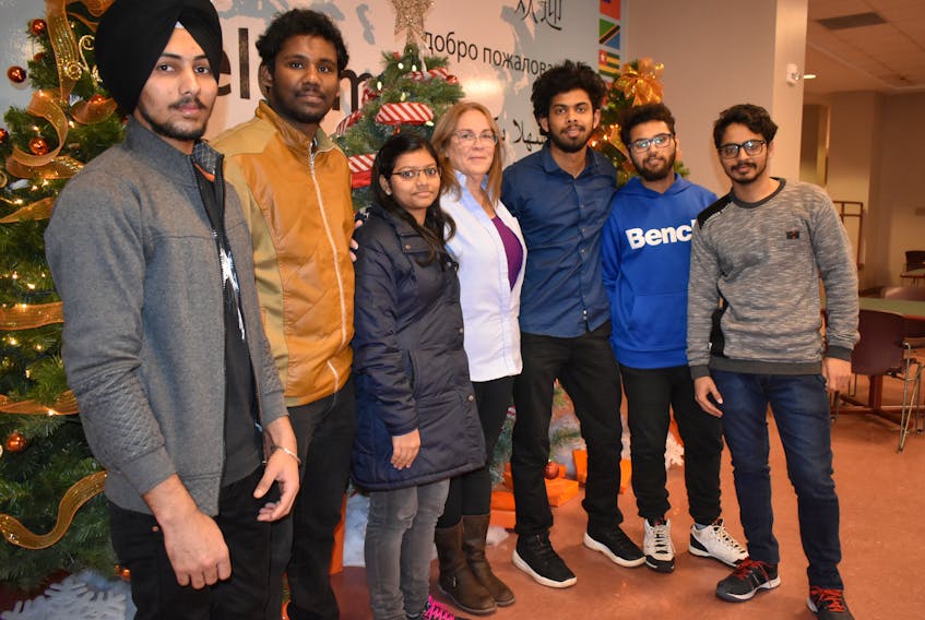 Paula Marsh from Purolator Courier, centre, stands with a group of Indian students near the cafeteria at CBU on Dec. 5. The students jumped at the last minute to help collect food for the company’s local food drive during the Sydney Santa Claus Parade and Marsh said it wouldn’t have happened without them. The Indian students are, from left, Ranjit Singh, Samual Shaji, Sneha Kurian, Shinil George, Adarsh Mahesh Nair and Gursewak Singh.