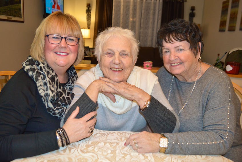 Lucy Chiasson, centre, 87, of New Waterford, has a little fun while relaxing at her home with Allana MacNeil, left, a daughter-in-law, and Gloria McNeil, a friend and her caregiver for her recent trip to Toronto, both also of New Waterford. The family say Chiasson has mobility issues and although they communicated the need for a wheelchair and ramp assistance for her, they were dismayed to later discover she had to walk up a ramp on her flight to Toronto and was carried off the plane in an adjustable chair on the return flight.