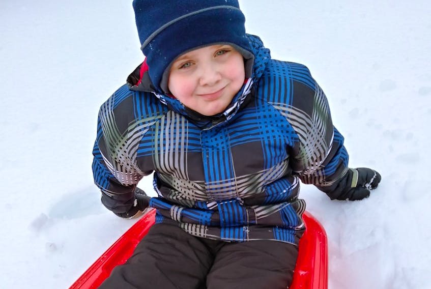 Seven-year-old Landon Baker from Sydney Mines loves to spend time outdoors. He was happy to do a little sledding last week during the late winter snowstorm.
