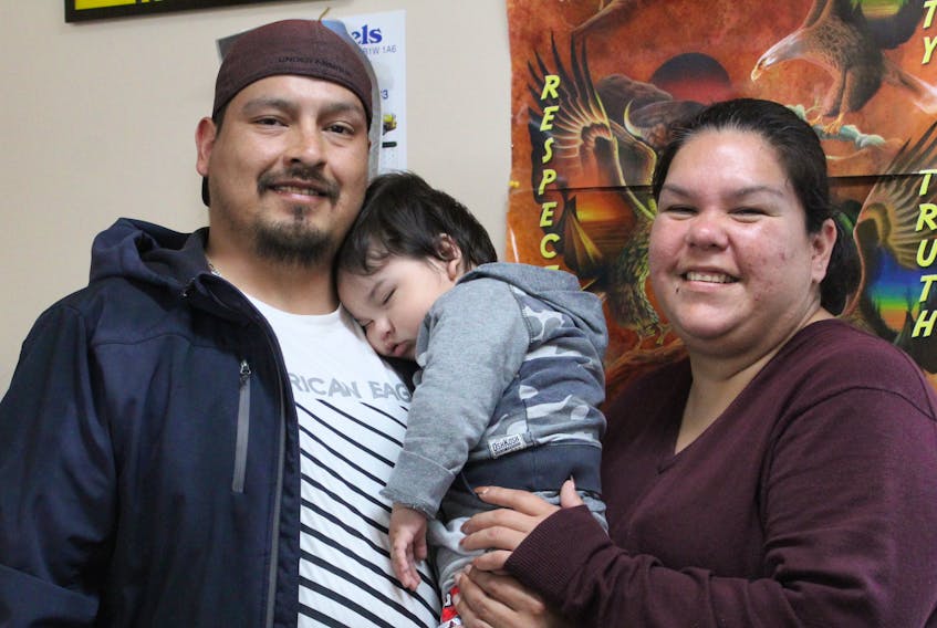 Michael Marshall holds his sleeping son, one-year-old Hoss Doucette-Marshall, in one of the offices at the Mi’kmaq Treatment Lodge Centre on June 6. Beside him is his partner, Samantha Doucette. Marshall is a survivor of physical and sexual abuse which he said lead him down the destructive path of drug abuse and alcoholism. Now dedicated to sobriety so he can provide a better life for his family, Marshall believes men often have a hard time talking about traumas they’ve suffered and thinks more resources are needed to help them get through.