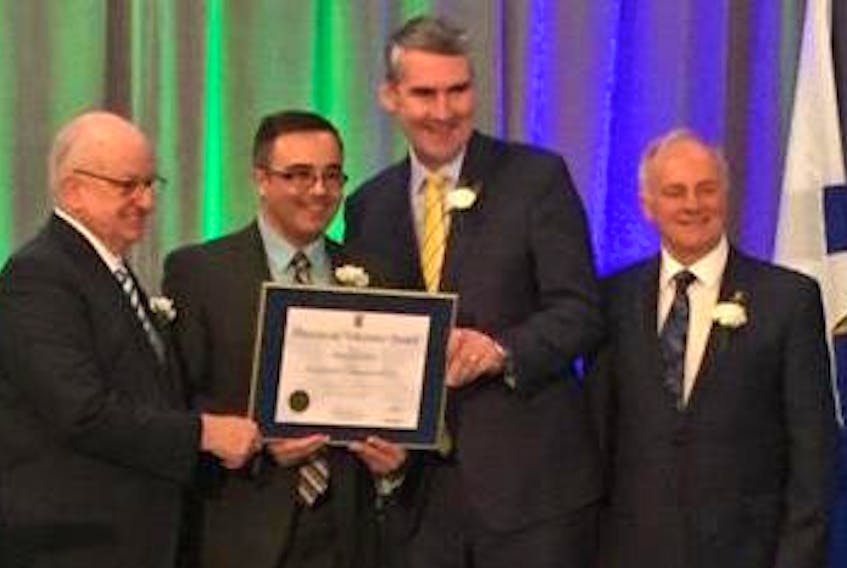 Mike Kelloway, second from the left, chair of Bayitfoward in Glace Bay, accepts a volunteer award during the 2018 provincial volunteer awards ceremony in Halifax on Monday. Making the presentation are, from left, Lt.-Gov. Arthur LeBlanc, Premier Stephen McNeil and Communities, Culture and Heritage Minister Leo Glavine.