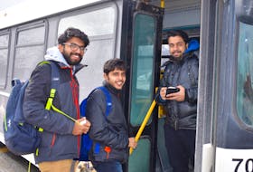 Alen Mathew Ninan, Athul Krishna and Vineeth Kumar are all smiles as they board a municipal transit bus at the Cape Breton University bus loop on Monday. The trio of petroleum engineering students from Karela, India, were not only happy to get out of the freezing cold, they were also pleased to learn that the province is spending $250,000 to help the Cape Breton Regional Municipality purchase three additional transit buses.