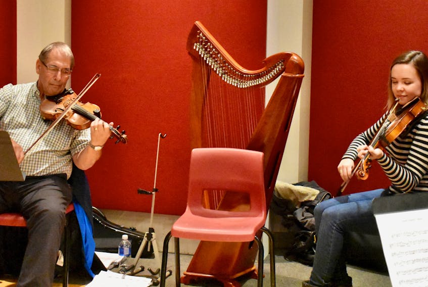 Stan Chapman, left, takes part in a jam session at Cape Breton University for Celtic Colours International Festival earlier this week led by Rachel Davis, a former student, right.