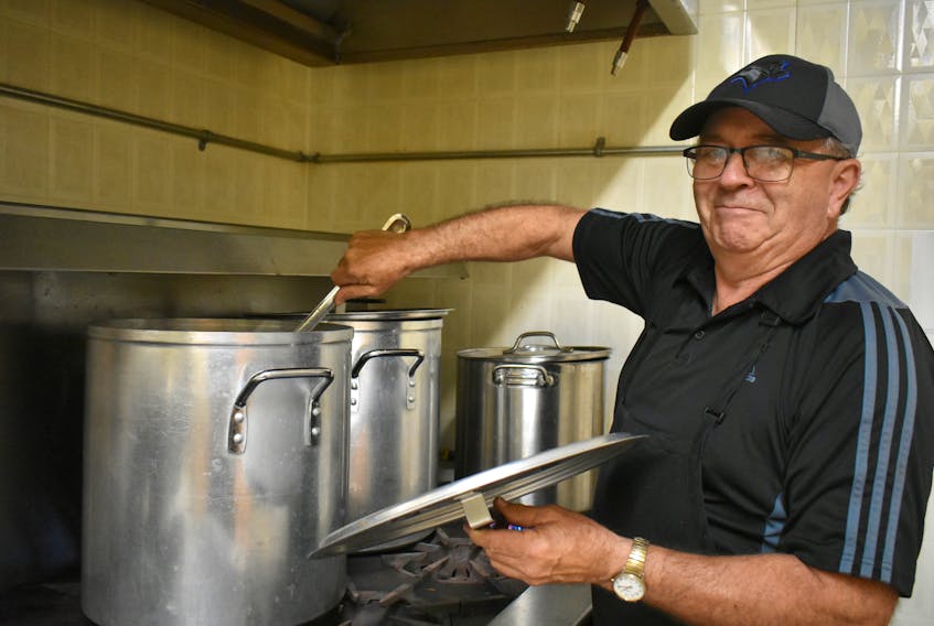 Tom Young, owner of Kitchen Party Catering and The Little Rollin’ Bistro, checks out one of three pots of corned beef being cooked for a community meal at Brooks Haven Seniors Recreation Centre in Prime Brook earlier this week. Between the three pots, 130 pounds of corned beef was being cooked for the 120 people expected to attend the traditional corned beef and cabbage meal, one of 74 community meals planned during this year’s Celtic Colours International Festival.