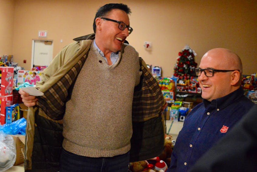Major Corey Vincent, right, of the Salvation Army shares a laugh with Sydney businessman Parker Rudderham in the toy room of the charitable organization’s Inglis Street community church. Rudderham, president and owner of Pharmacy Wholesale Services, made a $15,000 donation to the Sally Ann on behalf of his company. The local businessman says he wants to help the more than 600 former ServiCom employees who lost their jobs last week when the call centre shut down unexpectedly.
