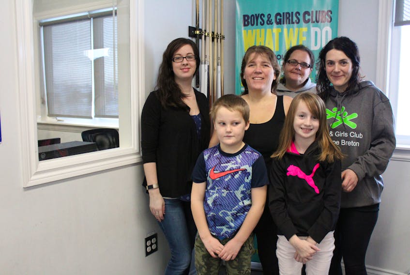 Michael Hussy, front left, and Taylor Butler-MacLean, front right, are both eight years old and in Grade 3 at Harbourside Elementary School in Whitney Pier. They are two of seven students who took part in a literacy pilot project put on by the Boys and Girls Club of Cape Breton from January 2018 to June 2018. The program was such a success, the organization is hoping to expand it to meet demand. Also in the picture are (back row from left): Nadine Butler (Taylor’s mother), Anita Hussey (Michael’s mother), Jillian Polegato and Rayanne Rogers.